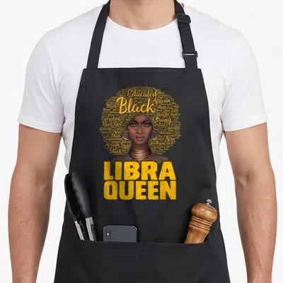 Libra african american aprons - Woman with afro word cloud and LIBRA QUEEN text in yellow — shown on a black cotton canvas apron against a white background