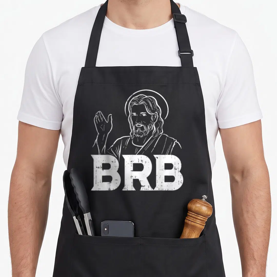 Brb christian apron - White line art of waving Jesus with halo above distressed BRB text — shown on a black cotton canvas apron against a white background