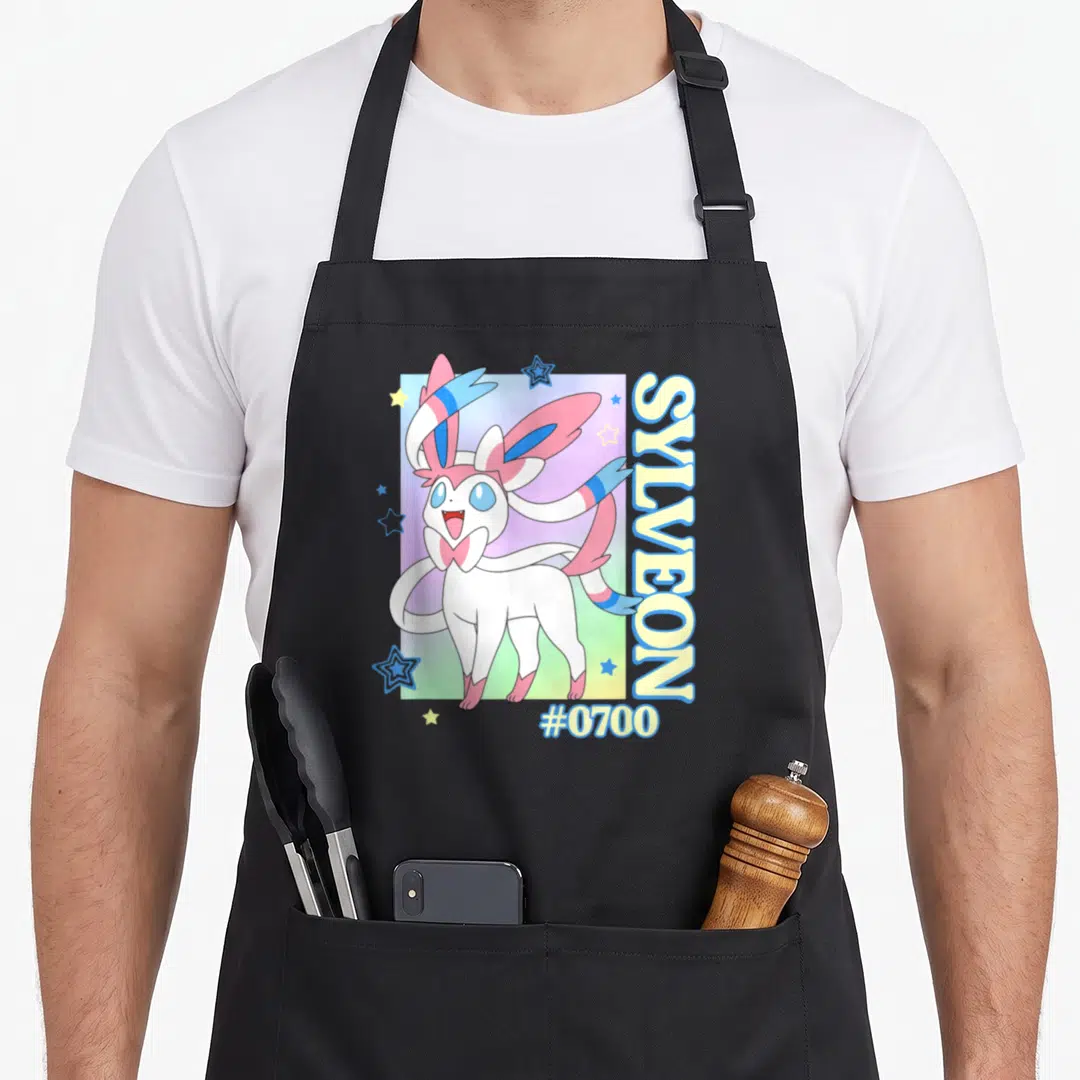 Sylveon colorful aprons - Sylveon #0700 cartoon on pink blue gradient with vertical text and stars — shown on a black cotton canvas apron against a white background