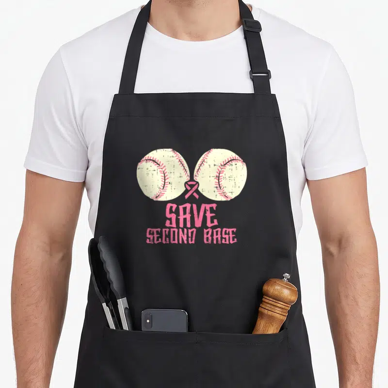 Save baseball apron - Two white softballs with pink ribbon and distressed SAVE SECOND BASE text — shown on a black cotton canvas apron against a white background