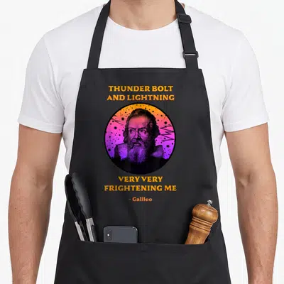 Thunderbolt science apron - Galileo portrait in circle with lightning bolts and stars, surrounded by yellow text — shown on a black cotton canvas apron against a white background