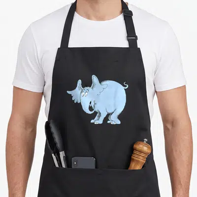 Horton elephant print apron - Light blue cartoon elephant with black outlines and curly tail — shown on a black cotton canvas apron against a white background
