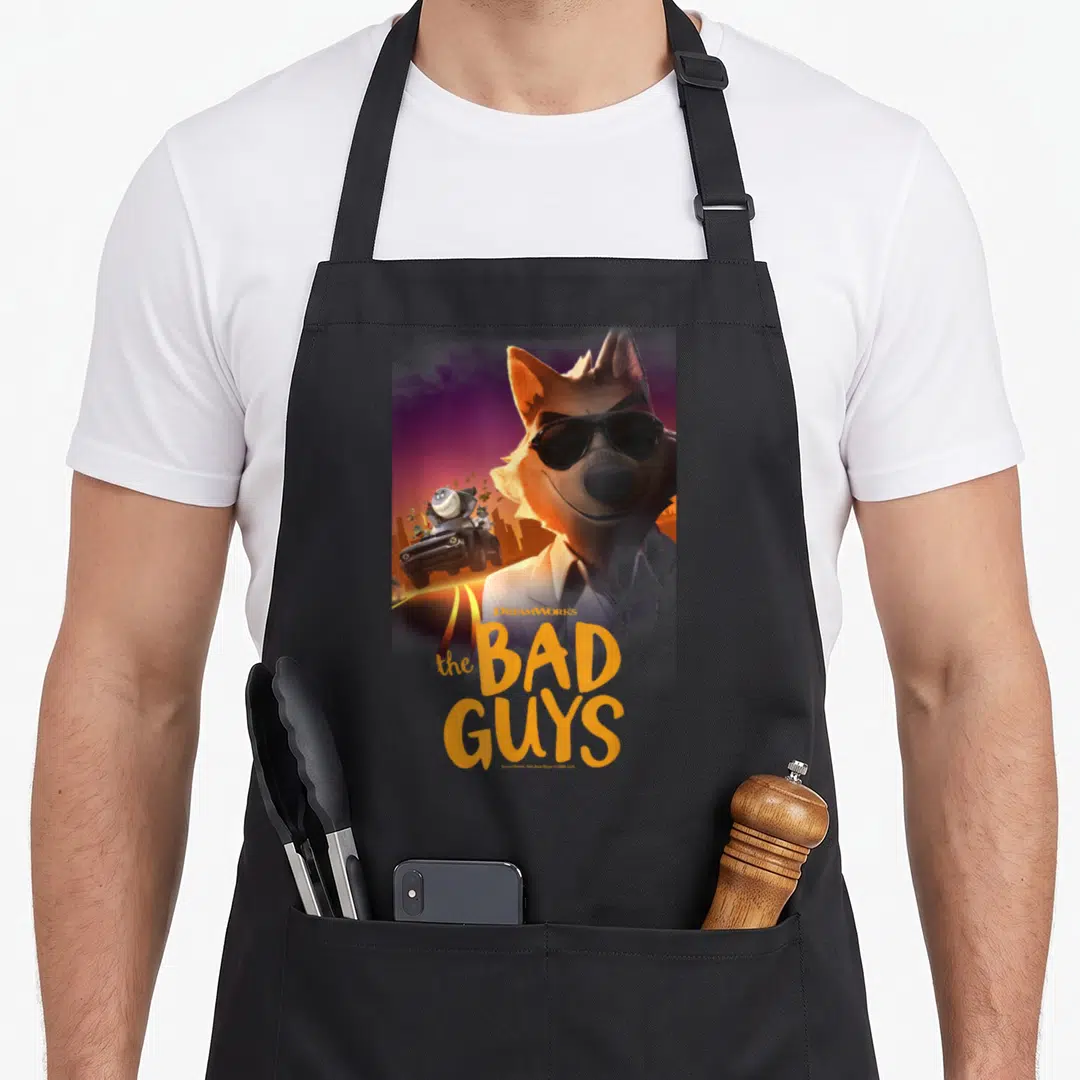 Wolf mr apron - Fox wearing sunglasses with The Bad Guys text and getaway car in orange and purple — shown on a black cotton canvas apron against a white background