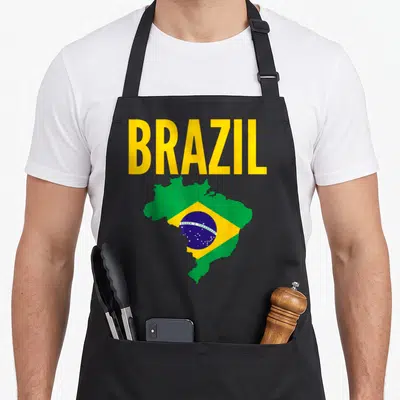 Brazil brazilian apron - Yellow BRAZIL text above a map of Brazil filled with green yellow and blue flag colors — shown on a black cotton canvas apron against a white background