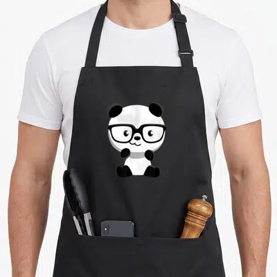 Nerd bear apron - Cartoon panda wearing glasses in black and white sitting pose — shown on a black cotton canvas apron against a white background