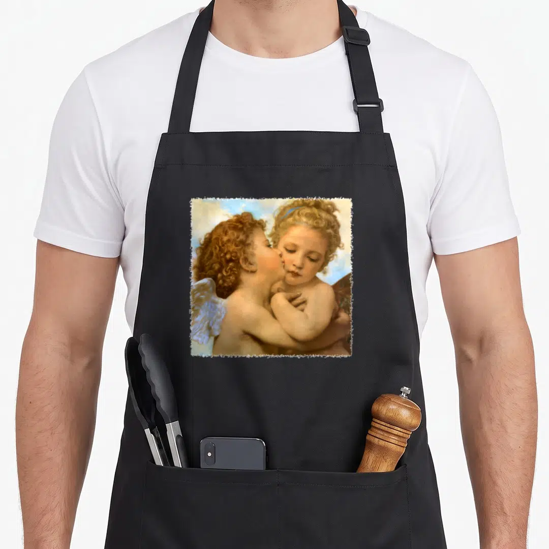 Detail angels in aprons - Two cherubs embracing and kissing inside a distressed white square frame — shown on a black cotton canvas apron against a white background