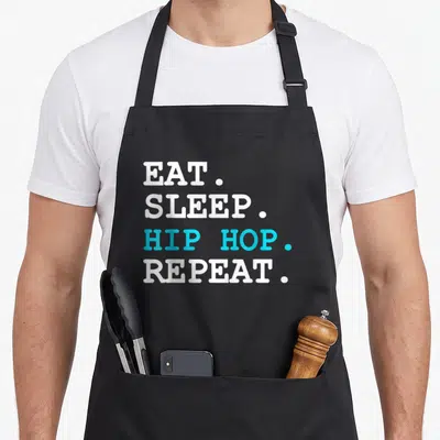 Dance hip apron - Stacked white and blue text reading EAT SLEEP HIP HOP REPEAT — shown on a black cotton canvas apron against a white background
