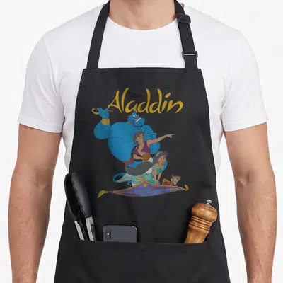 Funny shot novelty apron - Disney Aladdin Genie Aladdin Jasmine Abu magic carpet cartoon group shot — shown on a black cotton canvas apron against a white background