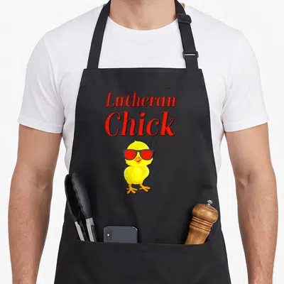 Martin rose apron - Red Lutheran Chick text above a yellow cartoon chick wearing black and red sunglasses — shown on a black cotton canvas apron against a white background