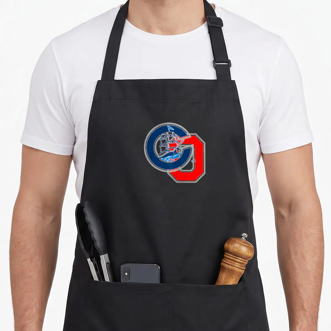 Funny columbus ohio apron - Cartoon ship inside blue circle overlapping large red letter G — shown on a black cotton canvas apron against a white background