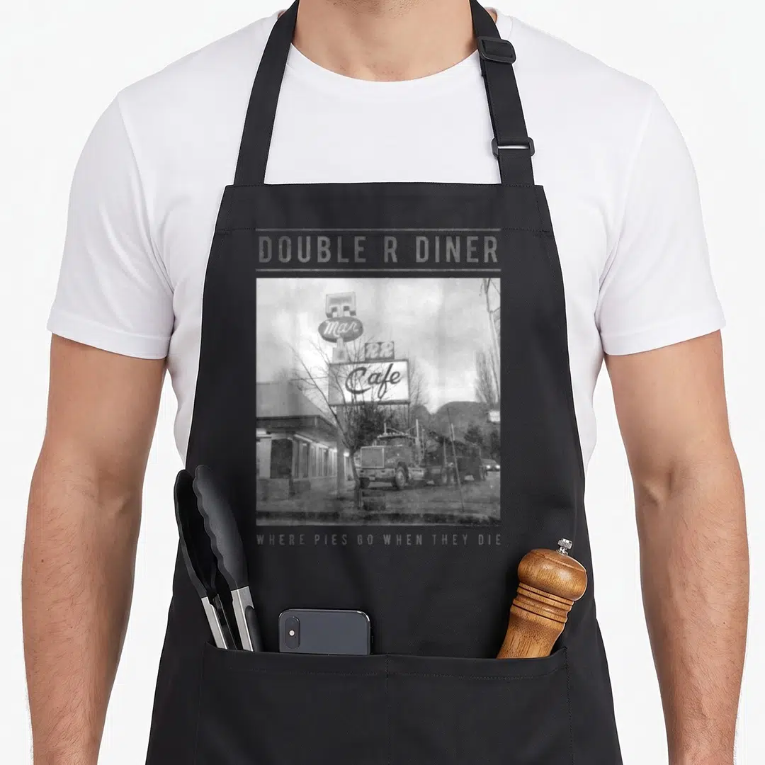 Peak double apron - Double R Diner photo with text Where Pies Go When They Die — shown on a black cotton canvas apron against a white background