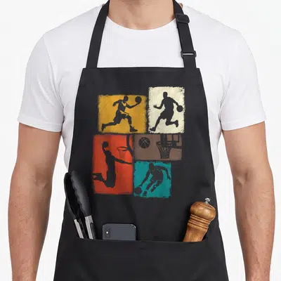 Player basketball boys apron - Four colored rectangles with grey basketball player silhouettes and hoop on grey — shown on a black cotton canvas apron against a white background