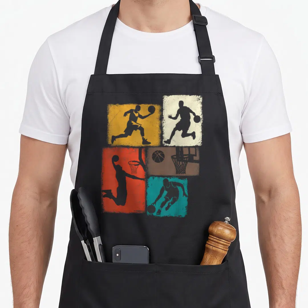 Player basketball boys apron - Four colored rectangles with grey basketball player silhouettes and hoop on grey — shown on a black cotton canvas apron against a white background