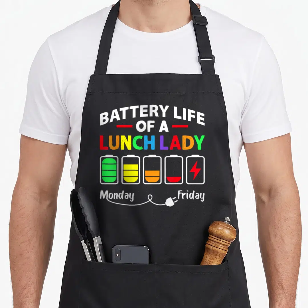 Battery school cafeteria aprons - Five colorful battery icons showing decreasing charge from green to red with plug — shown on a black cotton canvas apron against a white background