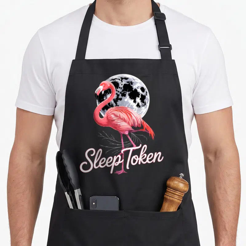 Sleep flamingo apron - Realistic pink flamingo standing in front of a moon with Sleep Token script text below — shown on a black cotton canvas apron against a white background