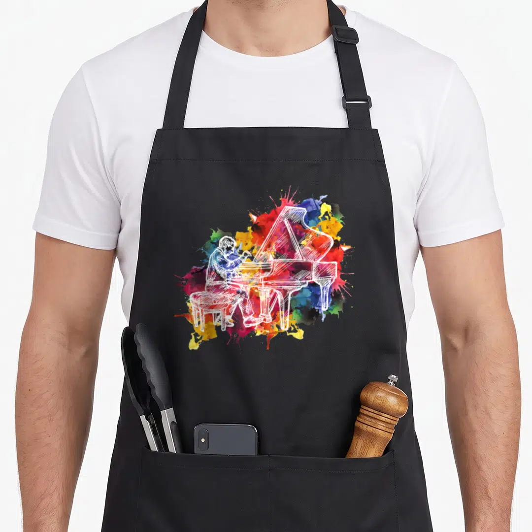 Pianist musician piano apron - White line drawing of pianist at grand piano on multicolored watercolor splash — shown on a black cotton canvas apron against a white background