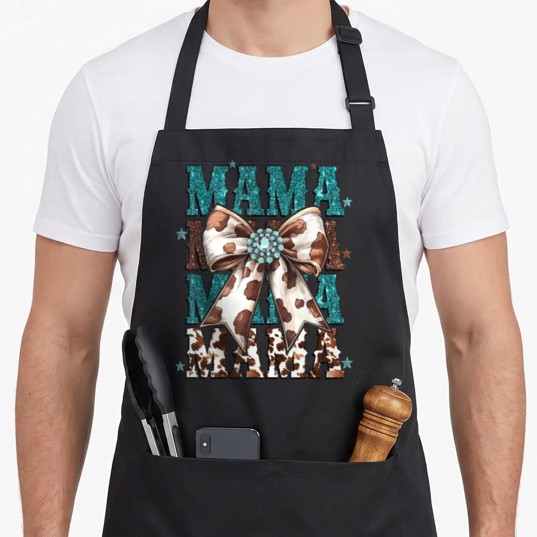 Cowboy cowgirl aprons - Stacked MAMA text with cow print bow and teal stars — shown on a black cotton canvas apron against a white background