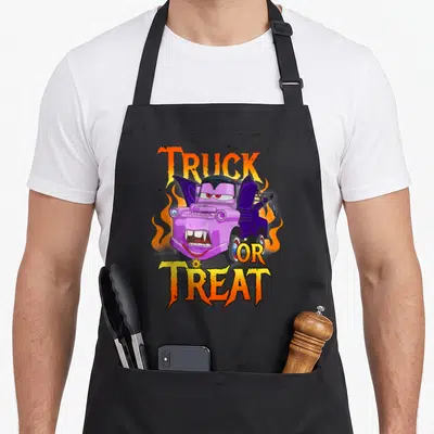 Halloween truck apron - Purple vampire tow truck with orange flames and TRUCK OR TREAT text — shown on a black cotton canvas apron against a white background