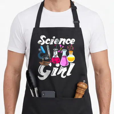 Chemist biology chemistry apron - Science Girl text surrounding cartoon microscope, flasks, thermometer, and molecular — shown on a black cotton canvas apron against a white background