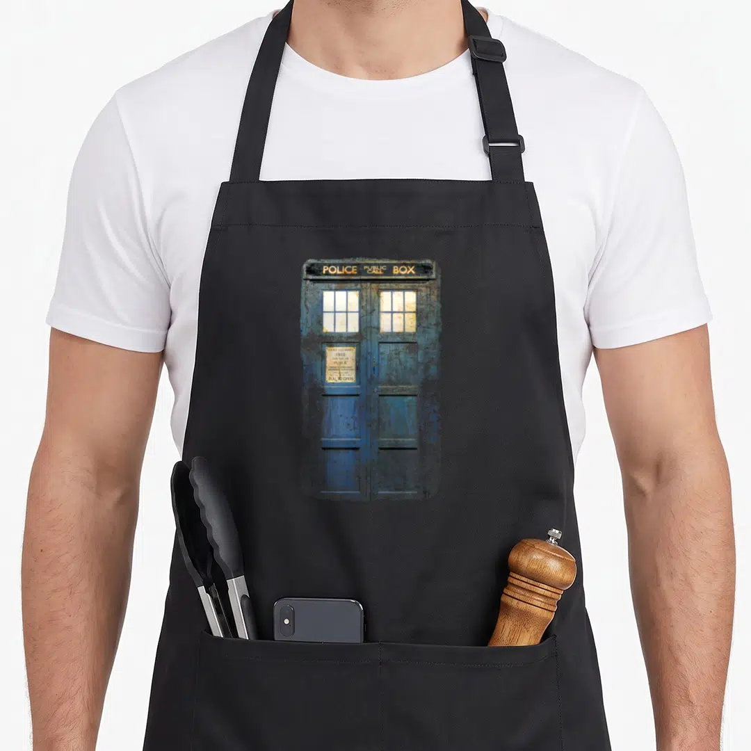Cosplay distressed apron - Weathered blue police public box with white sign reading free for use of public — shown on a black cotton canvas apron against a white background