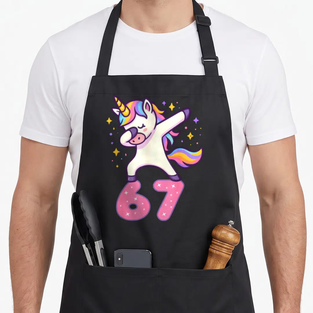 Brainrot meme apron - Cartoon unicorn standing on pink number 67 with colorful stars — shown on a black cotton canvas apron against a white background