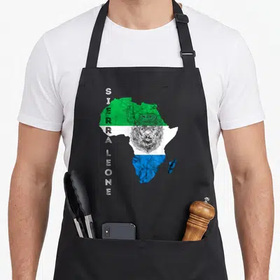 Leonean pride apron - Distressed map of Africa in green white and blue with vertical text and crowned lion head — shown on a black cotton canvas apron against a white background