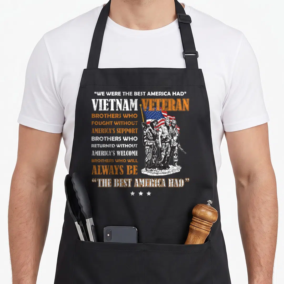 Vietnam veterans apron - Stacked text We Were The Best America Had beside standing soldiers and flag with three stars — shown on a black cotton canvas apron against a white background