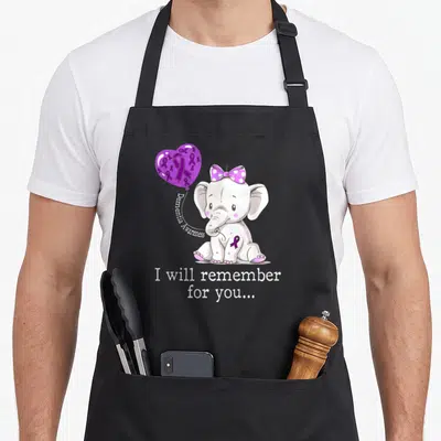 Elephant dementia awareness apron - Cartoon elephant with purple ribbon and text I will remember for you — shown on a black cotton canvas apron against a white background