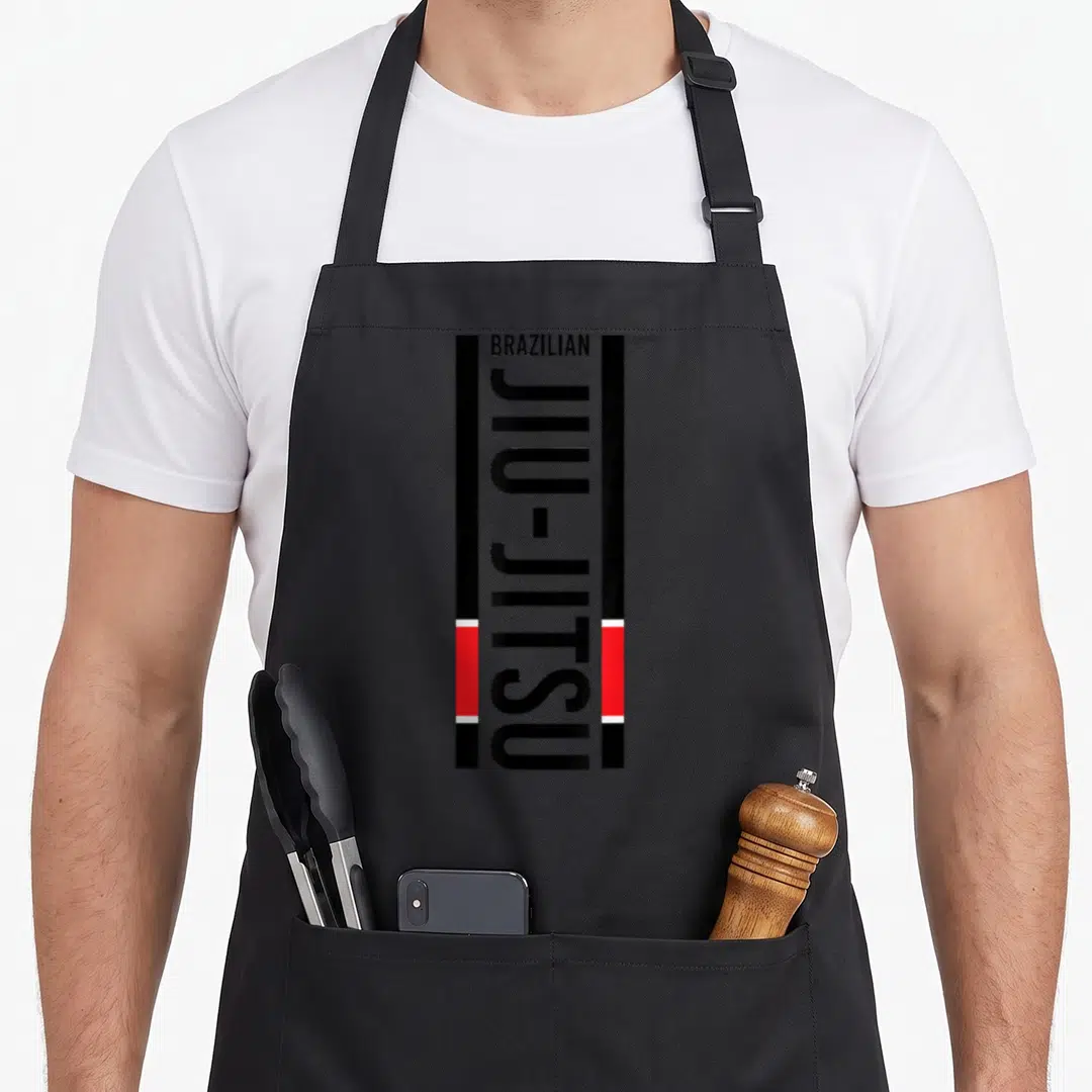 Belt brazilian apron - Vertical BRAZILIAN JIU-JITSU text flanked by black and red bars with white accents — shown on a black cotton canvas apron against a white background