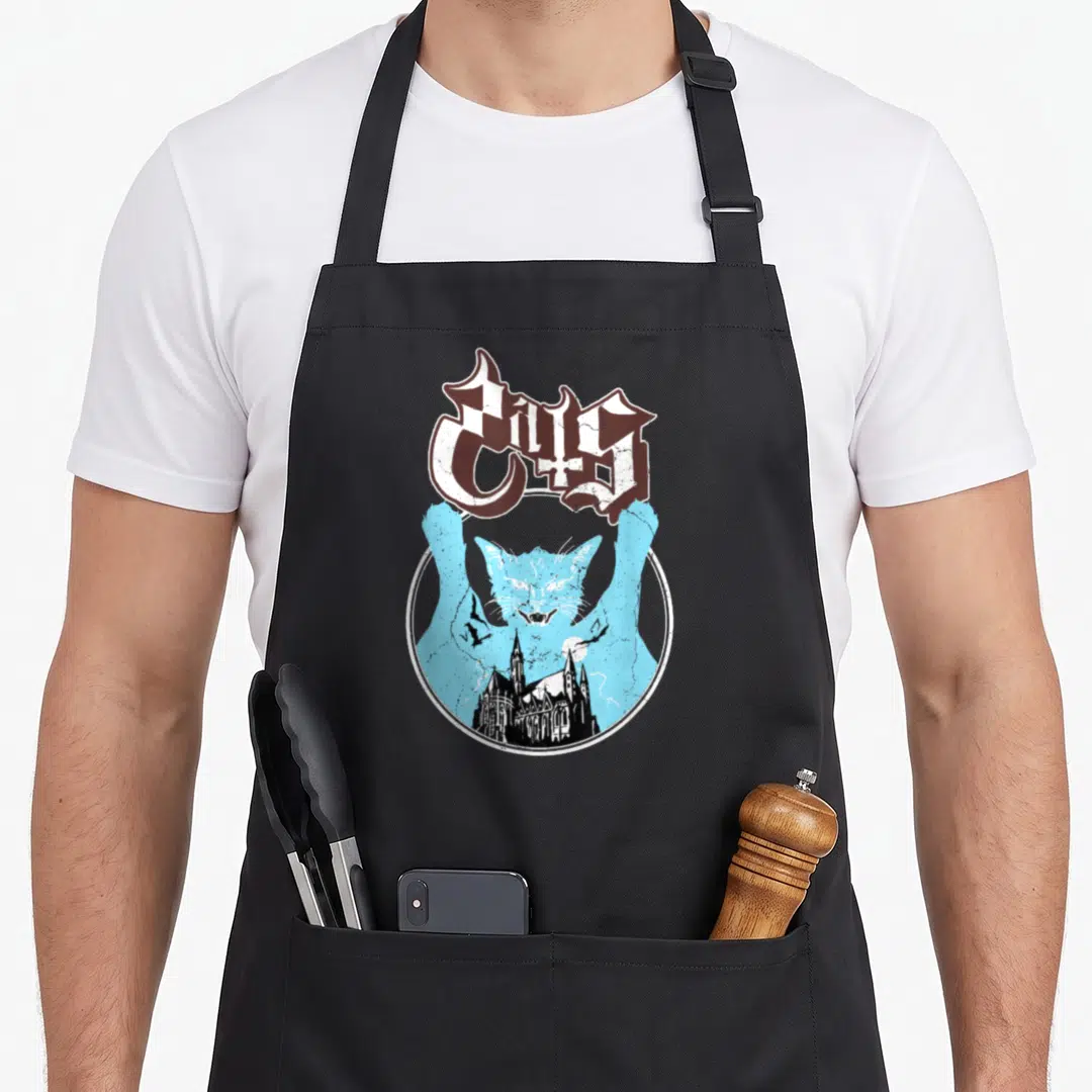 Ghost cat apron - Gothic Cats text above blue cat silhouette containing black cathedral, bats, moon, and lightning — shown on a black cotton canvas apron against a white background