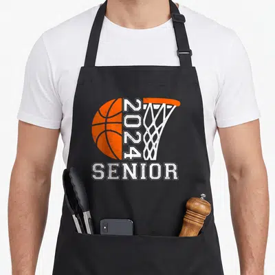 Senior graduate class player apron - Orange basketball and white hoop with vertical 2024 and large SENIOR text — shown on a black cotton canvas apron against a white background