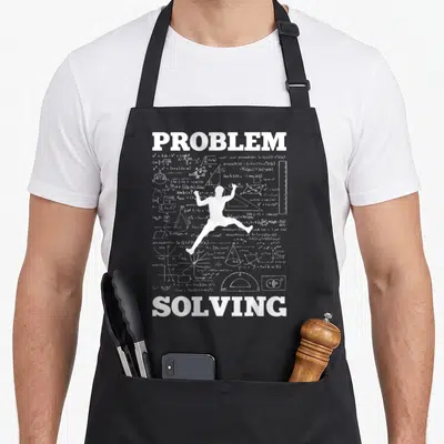 Solving bouldering apron - White person silhouette surrounded by math formulas between PROBLEM and SOLVING text — shown on a black cotton canvas apron against a white background