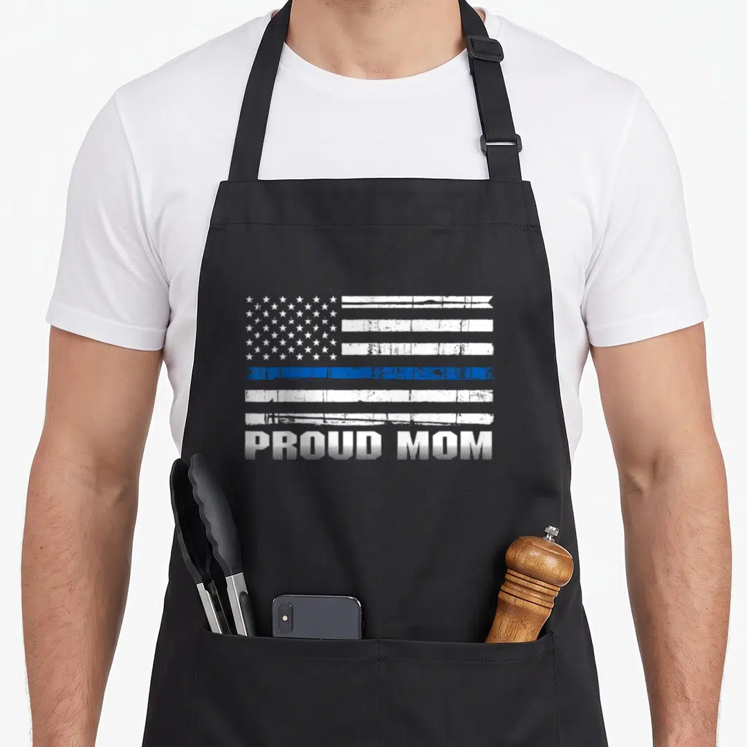 Enforcer police apron - Distressed white and blue flag above PROUD MOM text — shown on a black cotton canvas apron against a white background