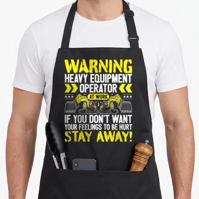 Stay heavy canvas aprons - Yellow excavators and warning text on canvas apron — shown on a black cotton canvas apron against a white background