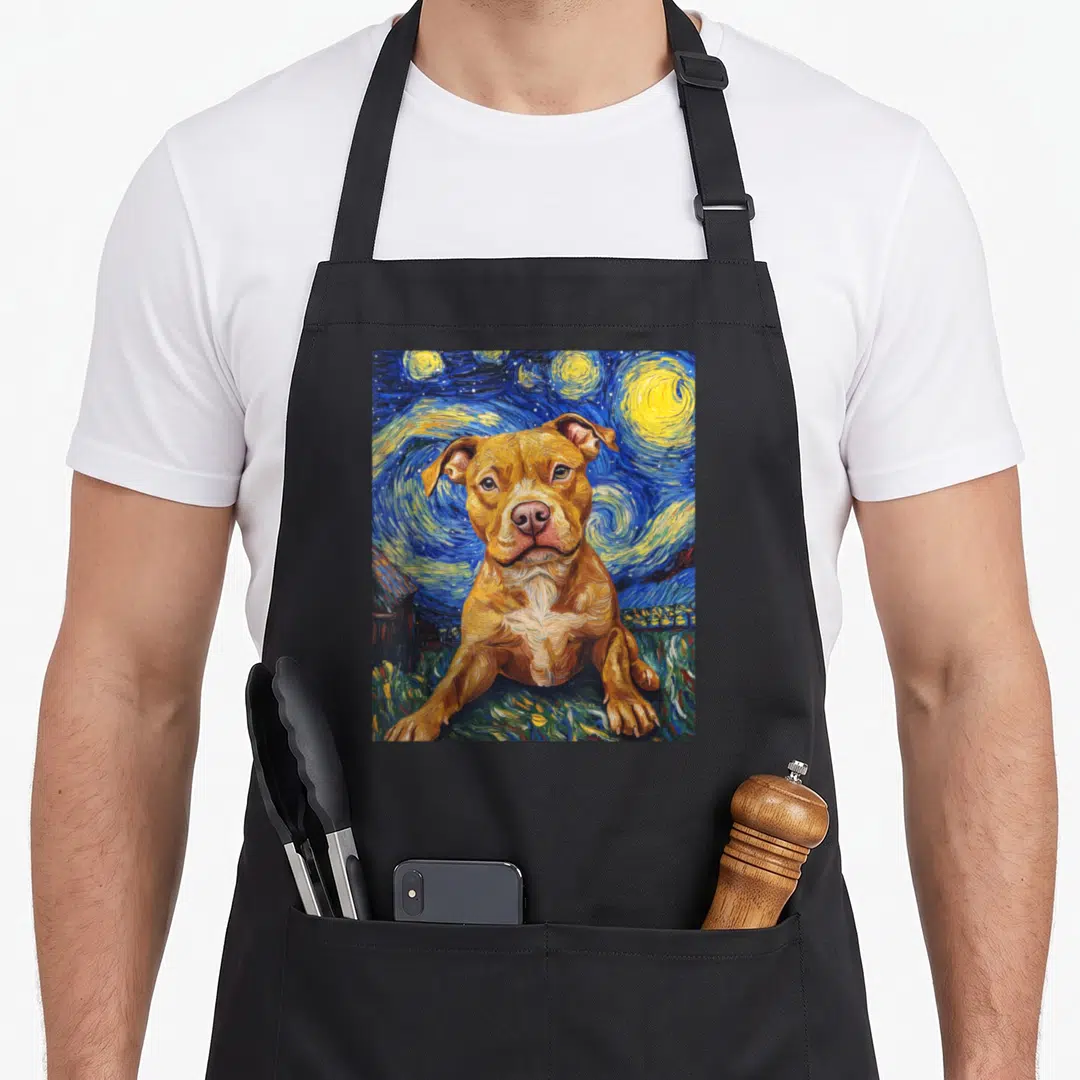 Pitbull van gogh apron - Brown dog lying on grass under blue yellow swirling starry night sky watercolor art — shown on a black cotton canvas apron against a white background