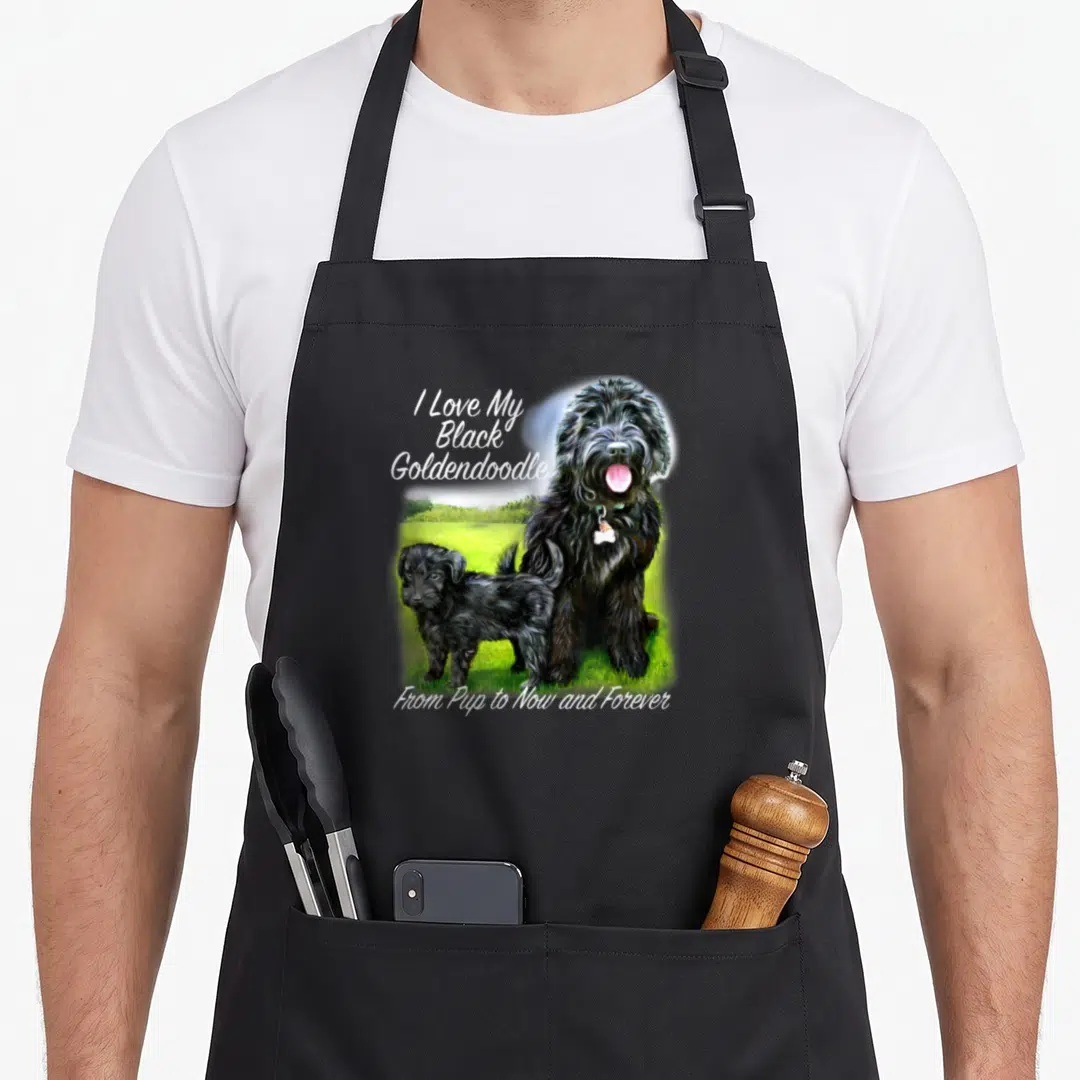 Pup goldendoodle apron - Realistic black adult dog and puppy on green grass with white text reading I Love My Black — shown on a black cotton canvas apron against a white background
