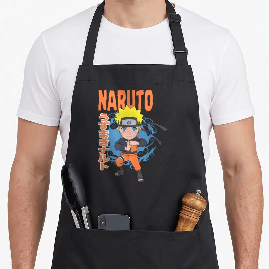 Pose anime apron - Chibi Naruto in orange outfit with NARUTO text and vertical Japanese characters against blue smoke — shown on a black cotton canvas apron against a white background