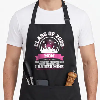 Proud graduation apron - Class of 2020 Mom graduate silhouette print with inspirational quote text — shown on a black cotton canvas apron against a white background