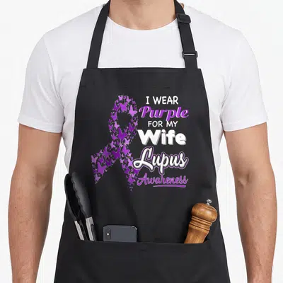 Lupus wife apron - Purple butterfly awareness ribbon with I WEAR Purple FOR MY Wife Lupus Awareness text — shown on a black cotton canvas apron against a white background