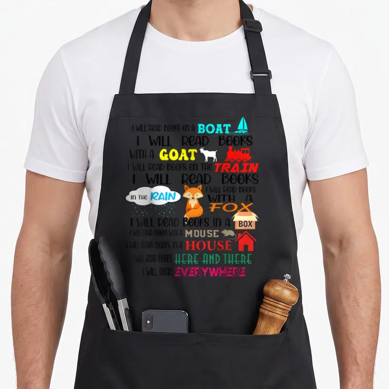 Boat teacher apron - Stacked text I Will Read Books On A Boat With A Goat Fox Mouse Box House Train Rain — shown on a black cotton canvas apron against a white background