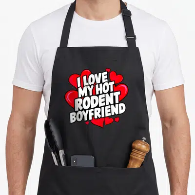 Cool hot i love my mouse apron - Stacked white text with black outlines layered on red hearts in cartoon style — shown on a black cotton canvas apron against a white background