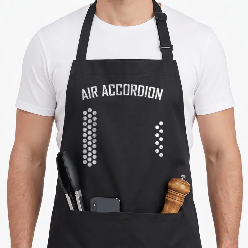 Funny air accordion apron - Arched AIR ACCORDION text above two vertical columns of white distressed circles — shown on a black cotton canvas apron against a white background