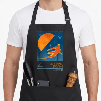 Studio future it apron - Retro blue poster with Human Torch flying before orange sun and Future Foundation text — shown on a black cotton canvas apron against a white background