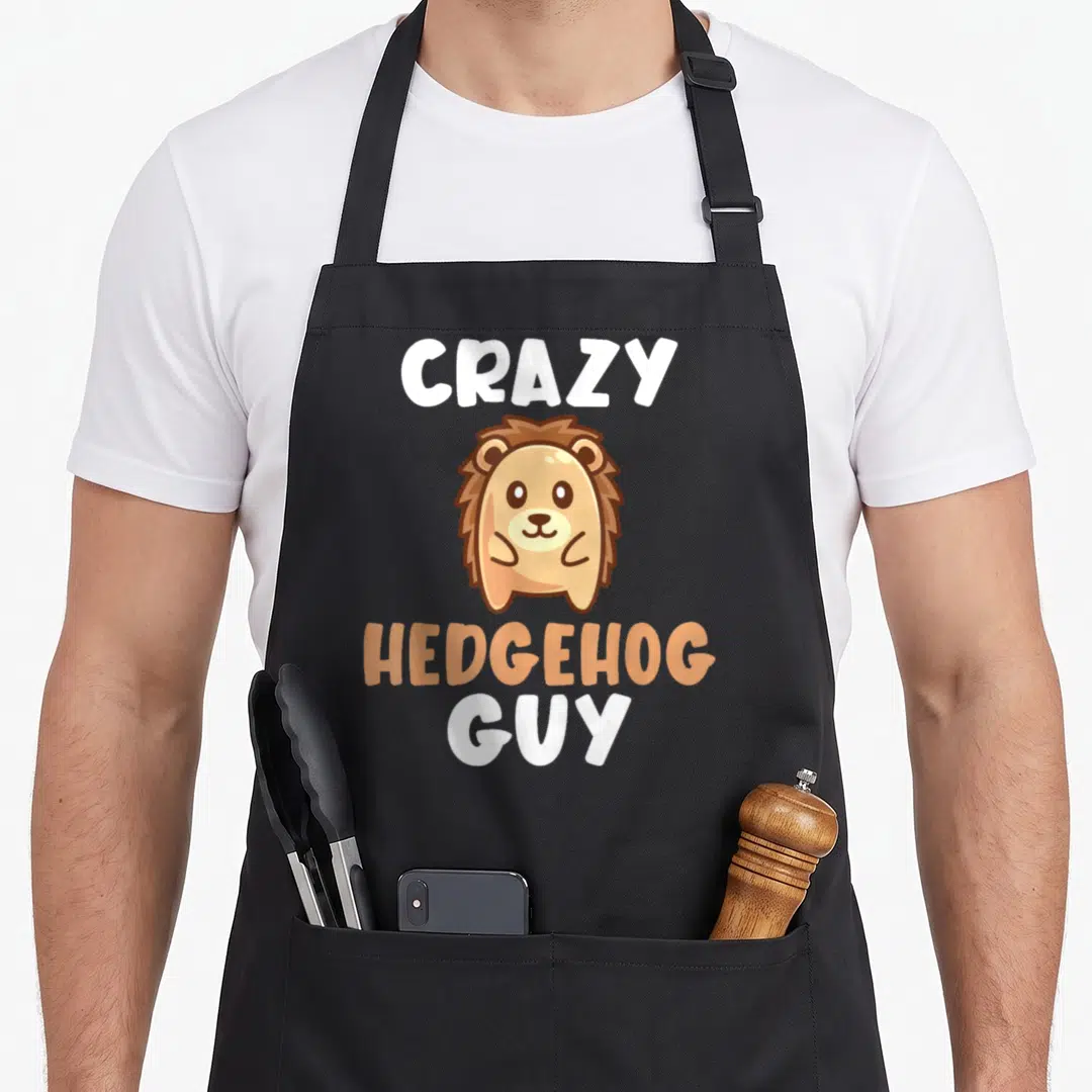 Crazy hedgehog woman apron - Cartoon hedgehog in tan and brown with text Crazy Hedgehog Guy — shown on a black cotton canvas apron against a white background