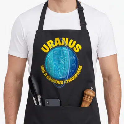 Astronomer atmosphere apron - Blue cartoon Uranus planet with yellow text arching above and below reading HAS A GASEOUS — shown on a black cotton canvas apron against a white background