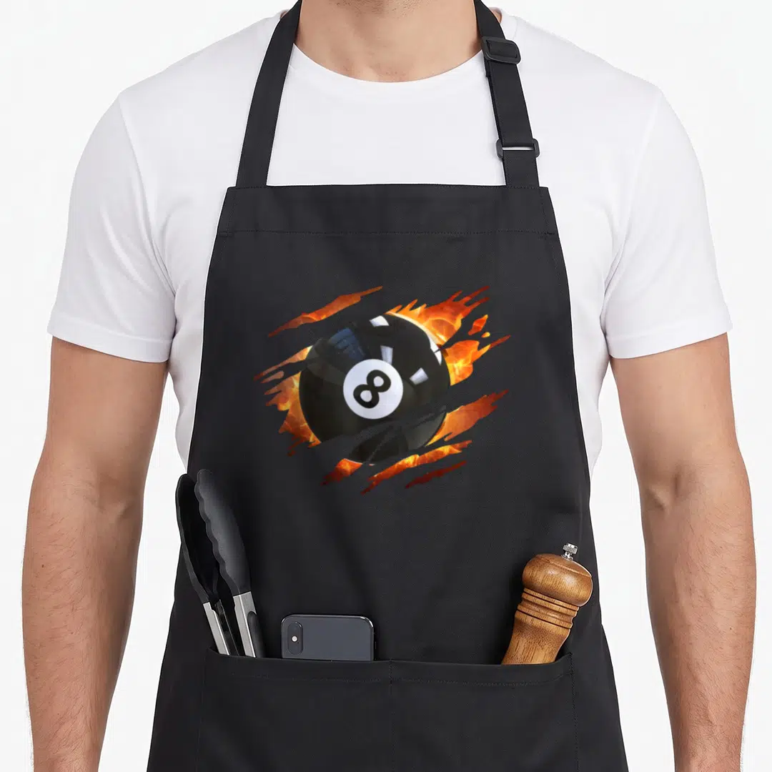 League billiards apron - Realistic black 8-ball bursting through grey surface with orange and yellow fire — shown on a black cotton canvas apron against a white background