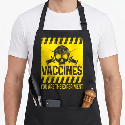 Mandatory vaccine apron - Distressed skull between two syringes with yellow and grey hazard stripes and text — shown on a black cotton canvas apron against a white background