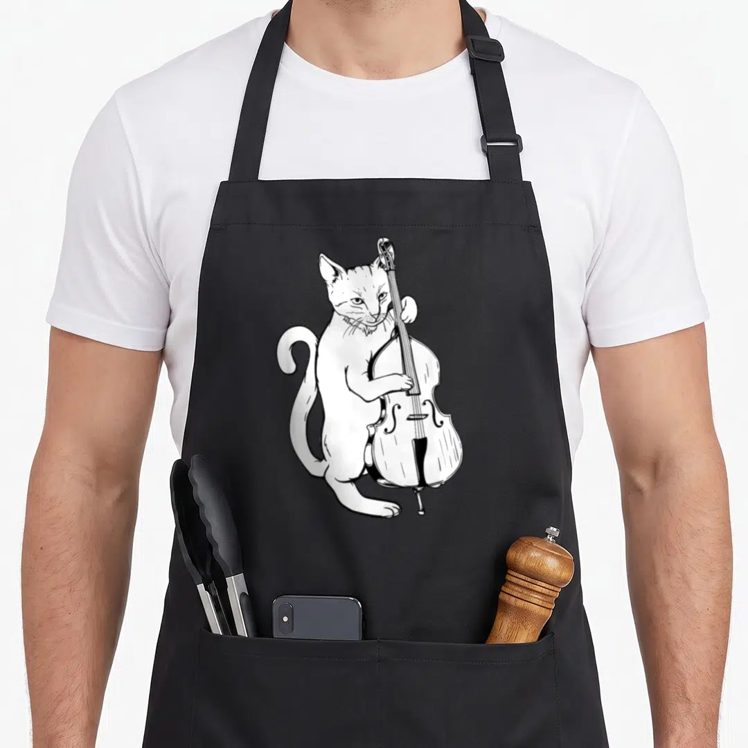 Upright cat apron - Line art of a standing white cat playing an upright bass with black outlines — shown on a black cotton canvas apron against a white background