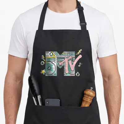 Mtv boombox era apron - Pink MTV letters over a grey boombox M with yellow lightning bolts and a star — shown on a black cotton canvas apron against a white background