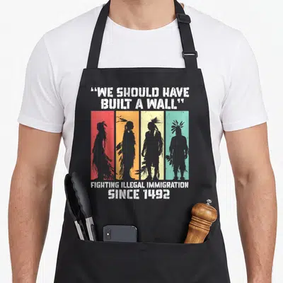 Built native american apron - Four grey silhouettes on red orange yellow green stripes with We Should Have Built A Wall — shown on a black cotton canvas apron against a white background